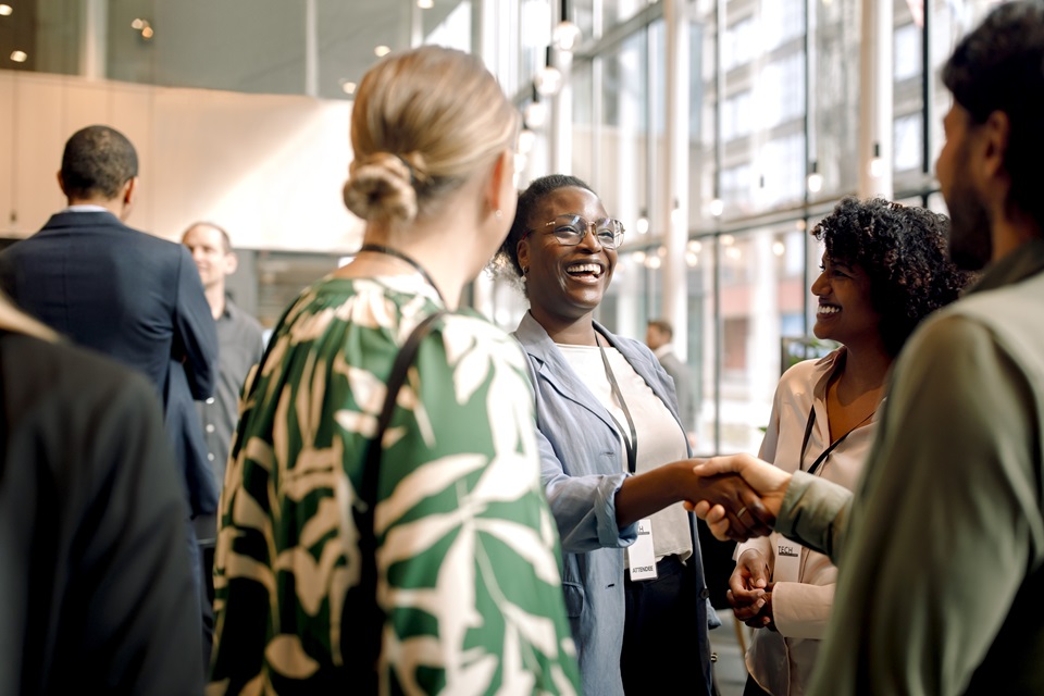 People shaking hands and meeting at an event
