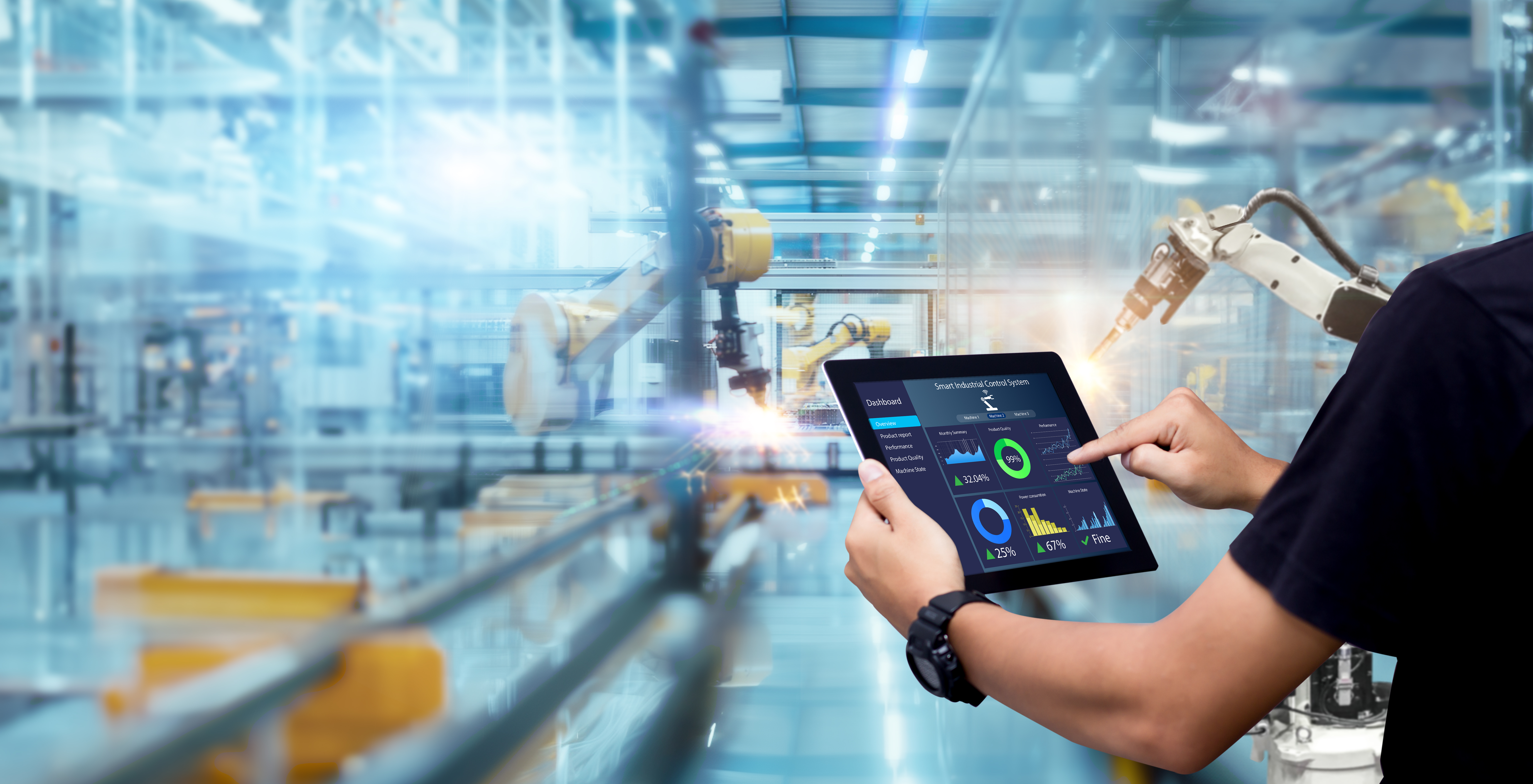 man using tablet to control AI-enabled robots in building