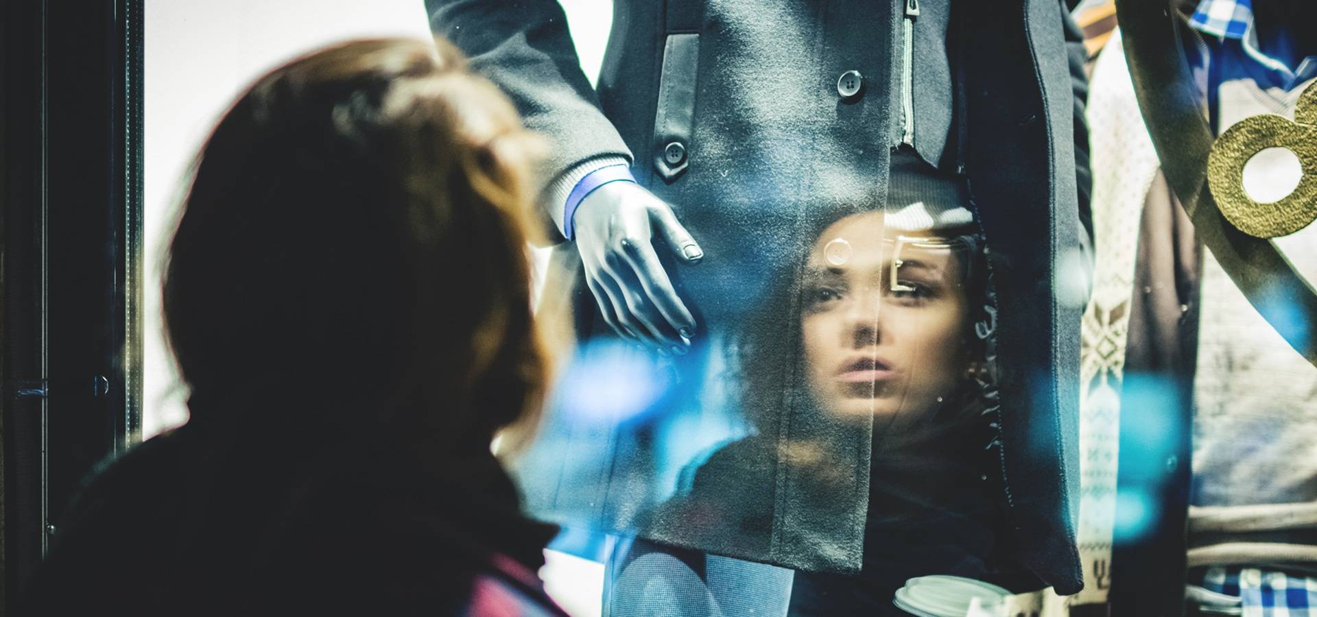 Person-looking-at-an-outfit-in-a-window-shop